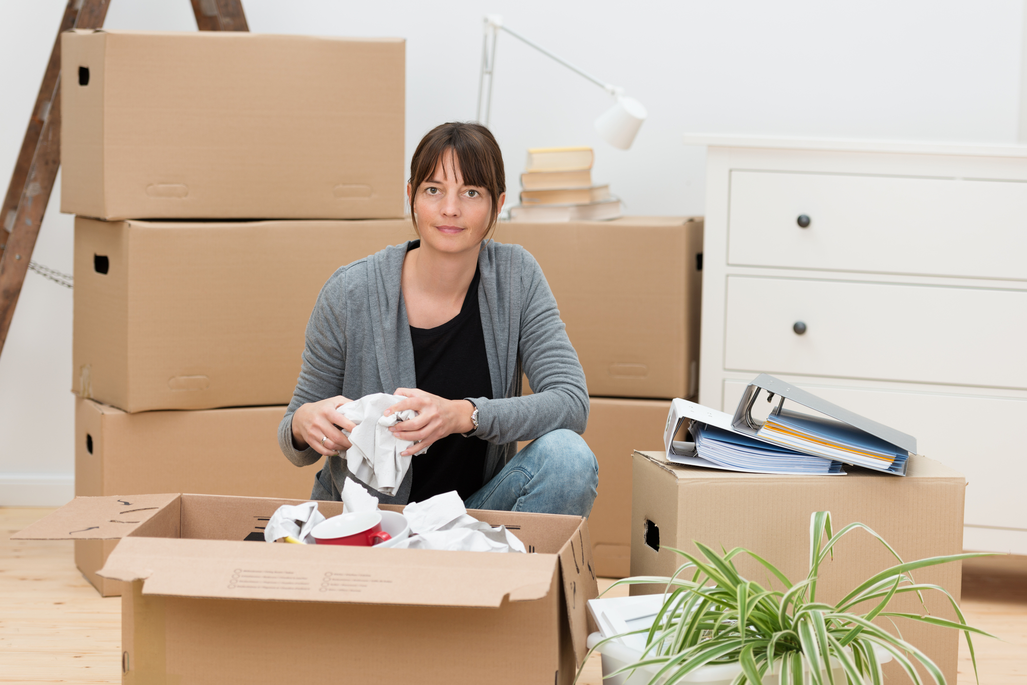 Woman moving house packing her belongings